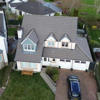 Professional roof cleaning service in Bolton, removing dirt and moss to restore roof's appearance